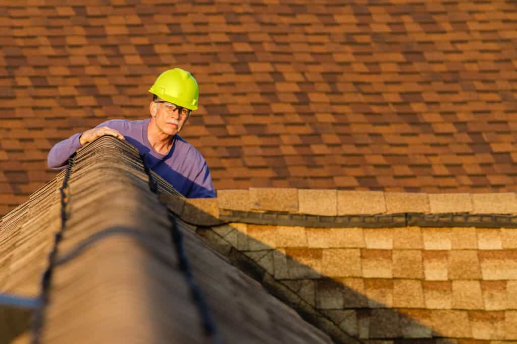 A roofer in Austin inspects a residential roofing system