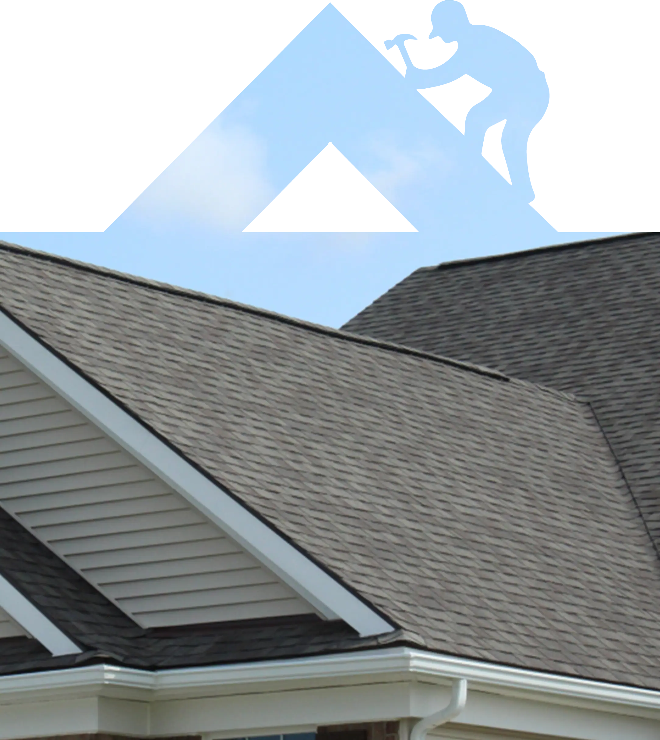 Close-up of a suburban home's roofing with grey shingles under a clear blue sky.