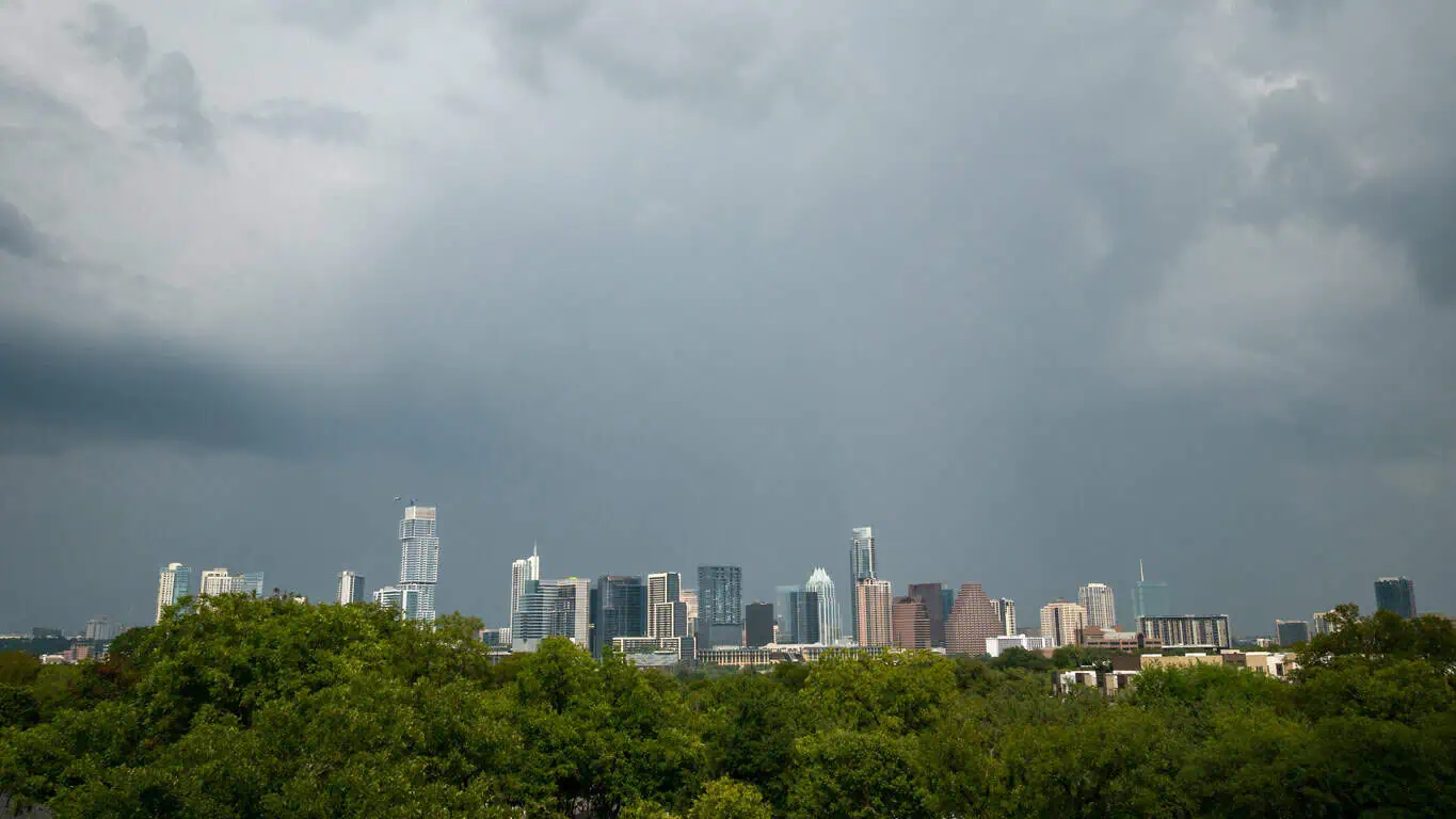 storm clouds over Austin skyline - how weather affects Austin roofing