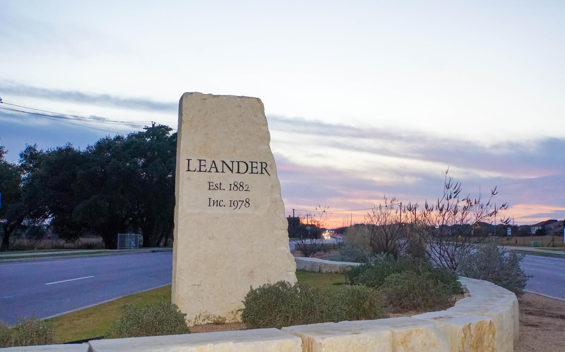 Historic Leander Stone Sign at Sunset – Highlighting Local Roofing Excellence