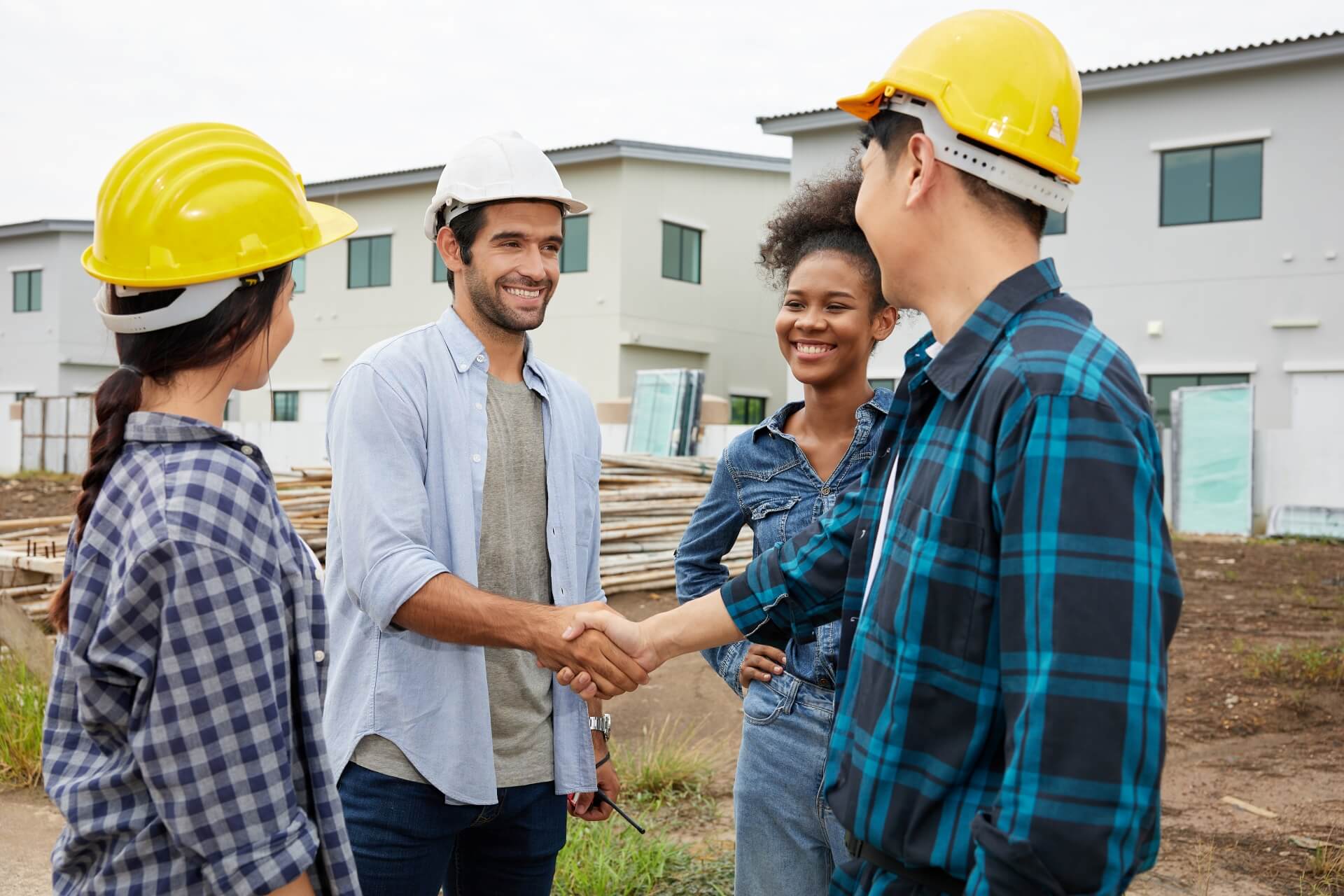 Construction workers celebrate project financing at bustling commercial roofing site.